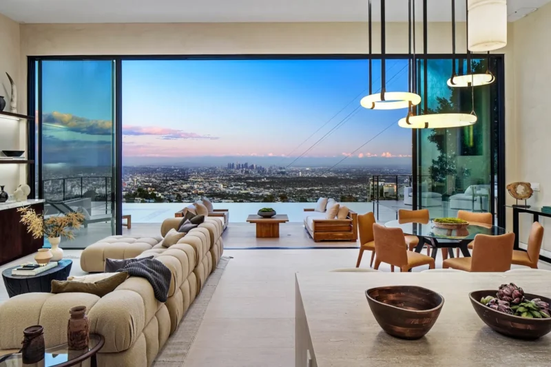 Great room with sectional sofa and open glass wall over the city